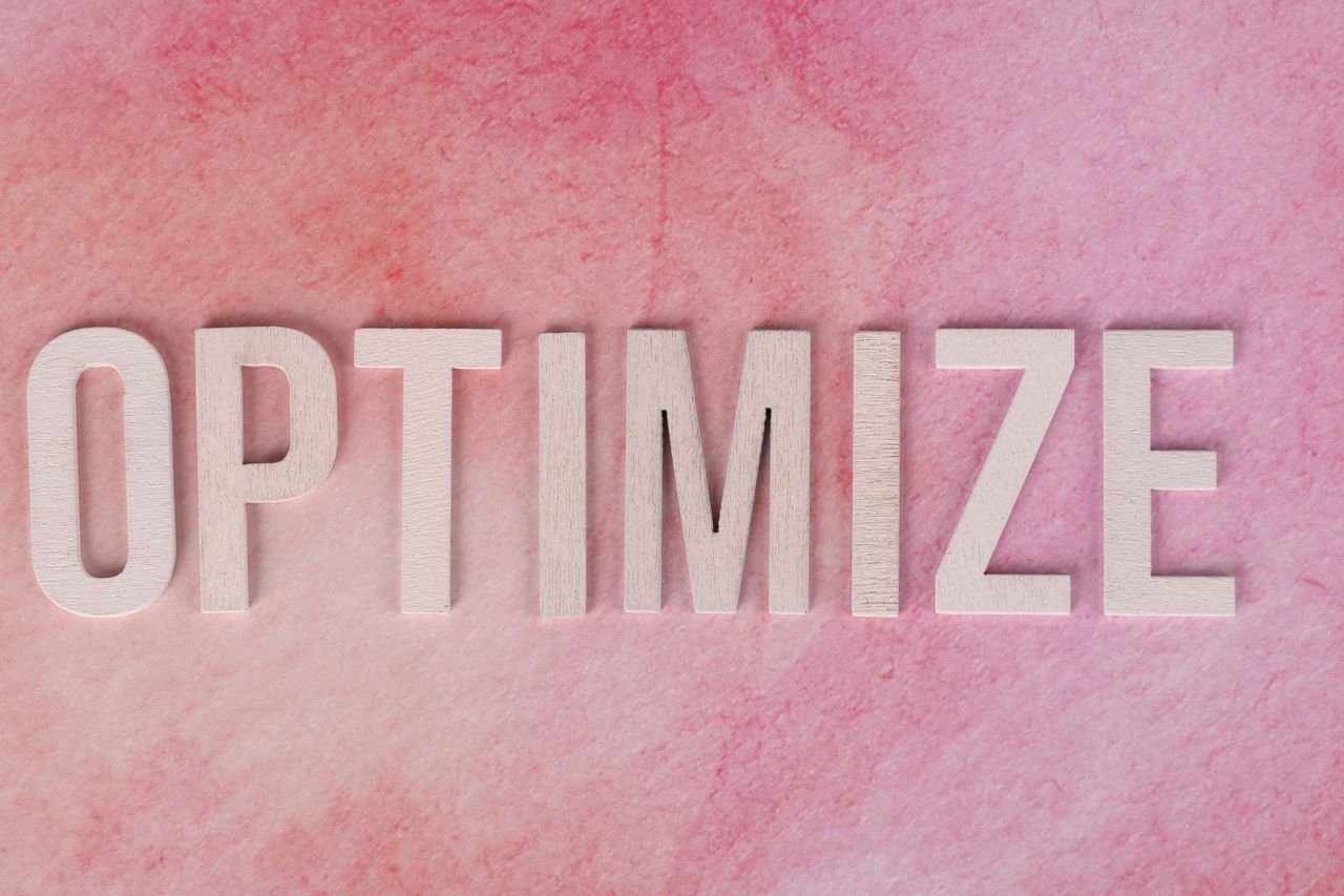 home-hero Creative display of the word 'OPTIMIZE' on a pink textured surface.